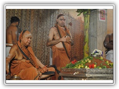 Their Holinesses performing Puja