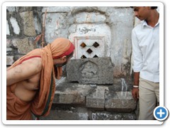 11. His Holiness keenly studying a Ganesha inscribed in a stone block