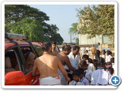 5. Distributing prasad to school children enroute.