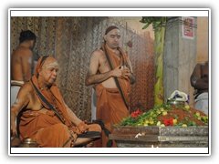 Their Holinesses performing Puja