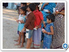 6. Children blessed with pens, fruits & biscuits.
